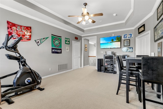 exercise area with visible vents, baseboards, carpet, a tray ceiling, and crown molding