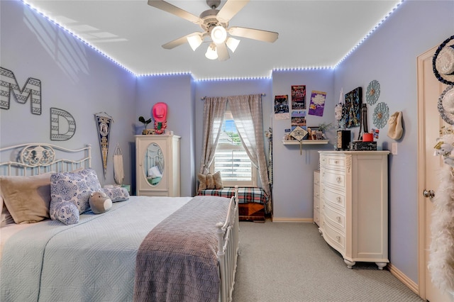 bedroom featuring light carpet, baseboards, and a ceiling fan