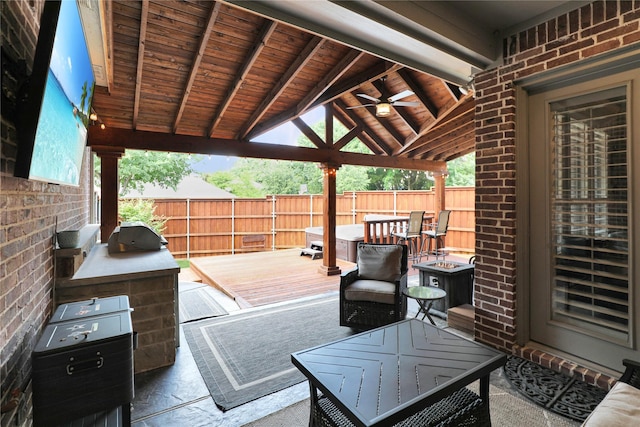 view of patio / terrace with a wooden deck, fence, and a gazebo