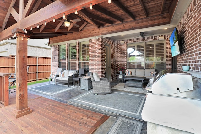 view of patio featuring fence, an outdoor living space, and ceiling fan