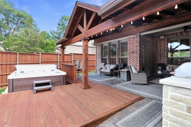 deck featuring outdoor lounge area, fence, and a hot tub