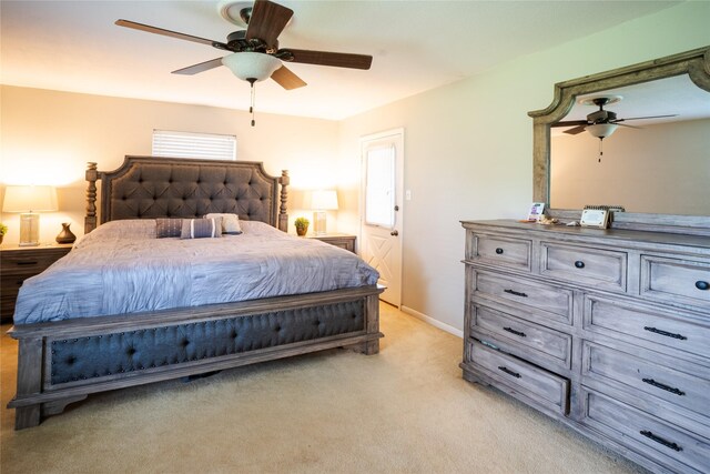 bedroom featuring ceiling fan, baseboards, and light colored carpet