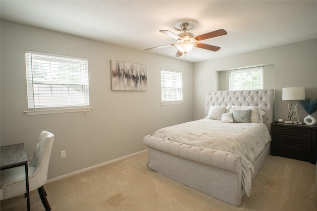 bedroom featuring light carpet, ceiling fan, and baseboards