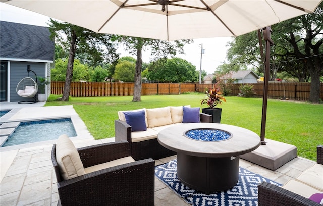 view of patio featuring a fenced backyard, a fenced in pool, and an outdoor living space with a fire pit