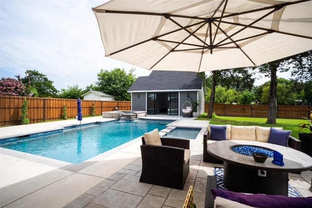 view of swimming pool with a storage structure, an outdoor fire pit, an outdoor structure, and a fenced backyard