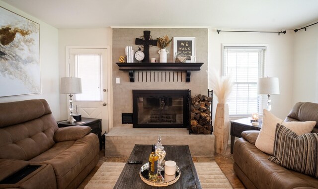 living area with a fireplace and a wealth of natural light