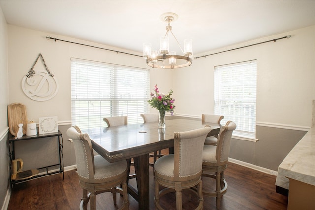 dining area with a healthy amount of sunlight, an inviting chandelier, baseboards, and dark wood finished floors