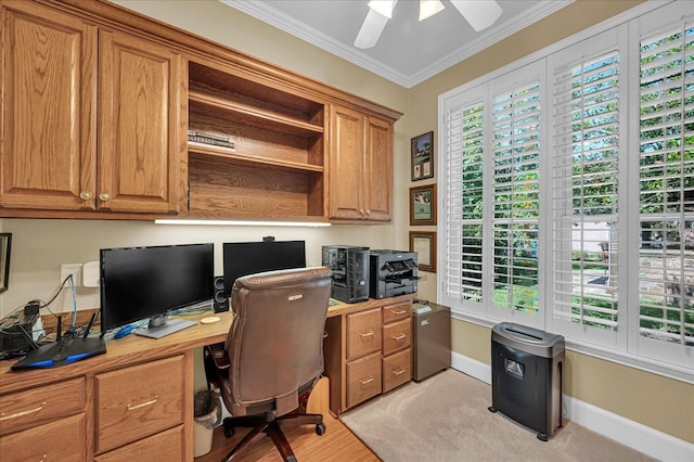 office area featuring baseboards, ornamental molding, light wood-type flooring, and a ceiling fan