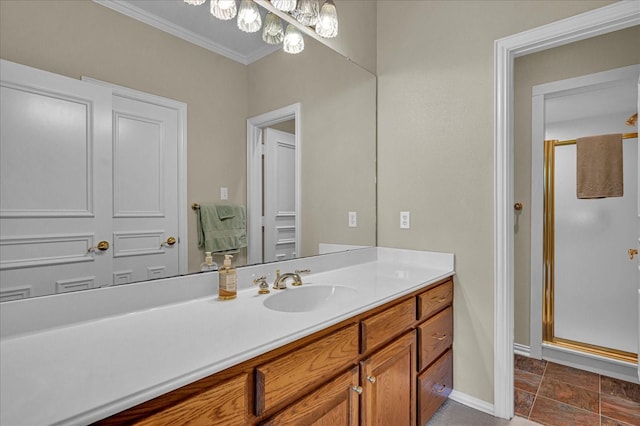 bathroom with an inviting chandelier, vanity, a stall shower, and crown molding