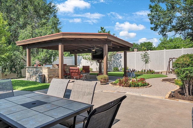view of patio with a fenced backyard, a gazebo, ceiling fan, and outdoor dining space