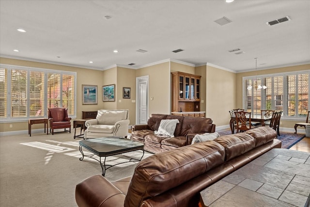 living room with baseboards, visible vents, and crown molding