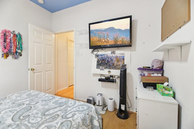 bedroom featuring baseboards and wood finished floors