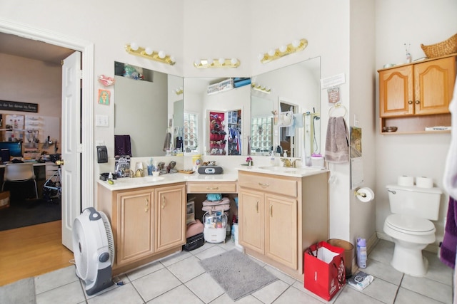 full bathroom with double vanity, tile patterned flooring, and a sink