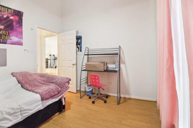 bedroom featuring baseboards and wood finished floors