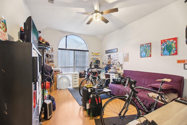 bedroom featuring lofted ceiling, visible vents, ceiling fan, and wood finished floors