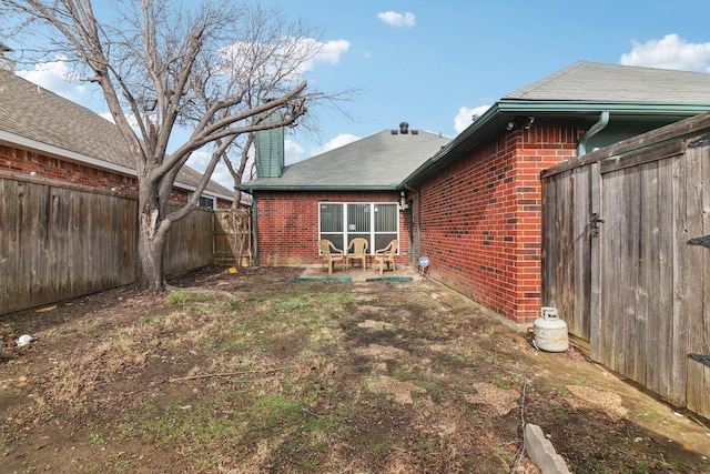 view of yard with a fenced backyard and a patio