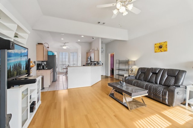 living room with light wood-type flooring, ceiling fan, visible vents, and recessed lighting