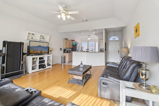 living room with light wood-style floors, visible vents, and a ceiling fan