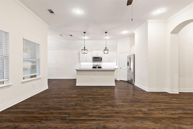 kitchen with dark wood finished floors, crown molding, visible vents, appliances with stainless steel finishes, and a ceiling fan