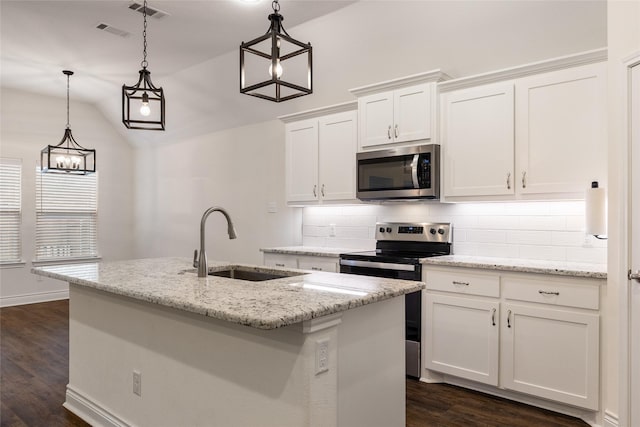 kitchen with visible vents, appliances with stainless steel finishes, decorative backsplash, and a sink