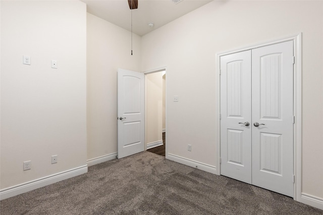 unfurnished bedroom with a ceiling fan, carpet, a closet, and baseboards