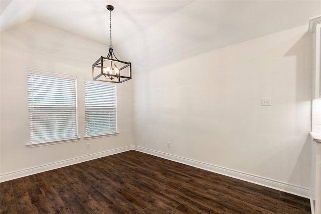 empty room with lofted ceiling, an inviting chandelier, baseboards, and dark wood finished floors