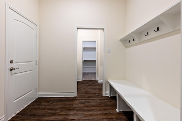 mudroom with dark wood-style flooring and baseboards