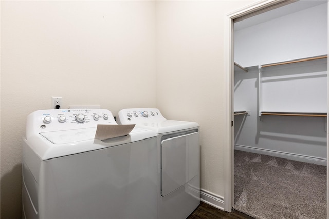 washroom featuring laundry area, washing machine and clothes dryer, and baseboards