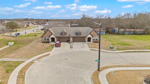 view of front of property with concrete driveway, a residential view, roof with shingles, an attached garage, and a front lawn