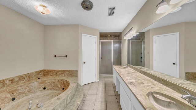 bathroom featuring double vanity, a stall shower, visible vents, a tub with jets, and a sink