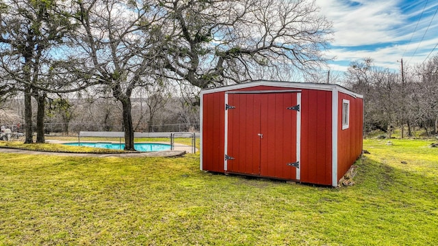 view of shed featuring fence and an outdoor pool