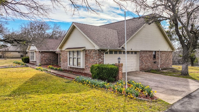 view of front of home featuring driveway, an attached garage, a front lawn, and brick siding