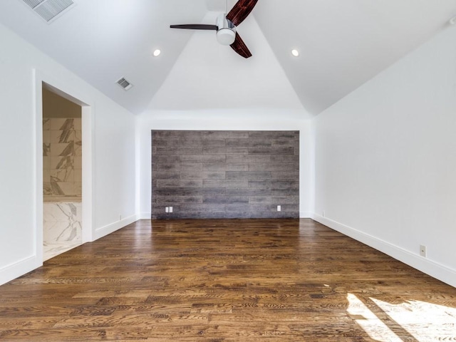 spare room with visible vents, wood finished floors, and a ceiling fan