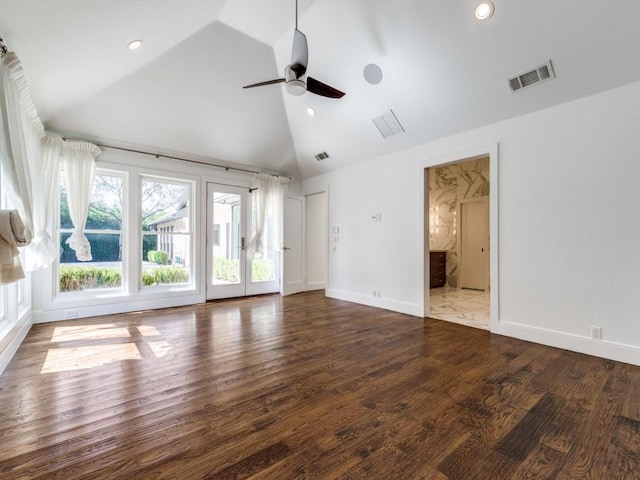 unfurnished living room with visible vents, high vaulted ceiling, a ceiling fan, wood finished floors, and baseboards