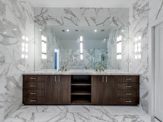 full bathroom with a sink and stone wall