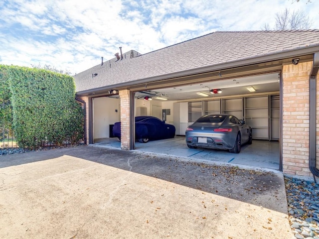 garage featuring a garage door opener and driveway