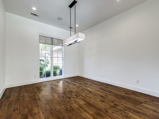 unfurnished dining area featuring recessed lighting, visible vents, baseboards, and dark wood-type flooring