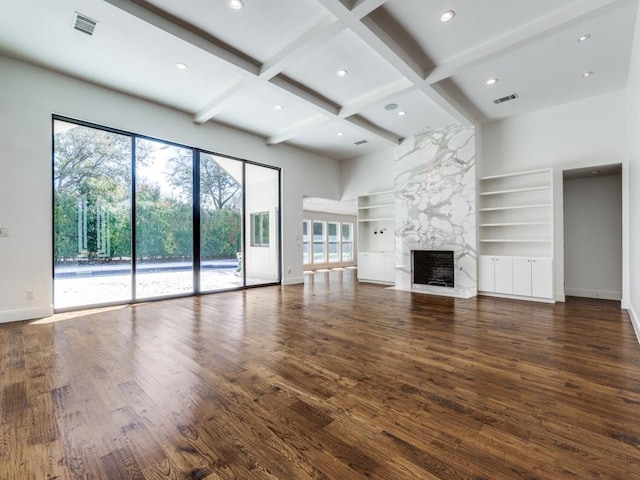 unfurnished living room featuring wood finished floors, baseboards, coffered ceiling, a premium fireplace, and beamed ceiling