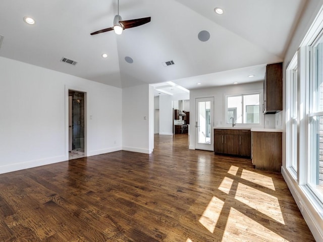 unfurnished living room with dark wood finished floors, baseboards, and visible vents