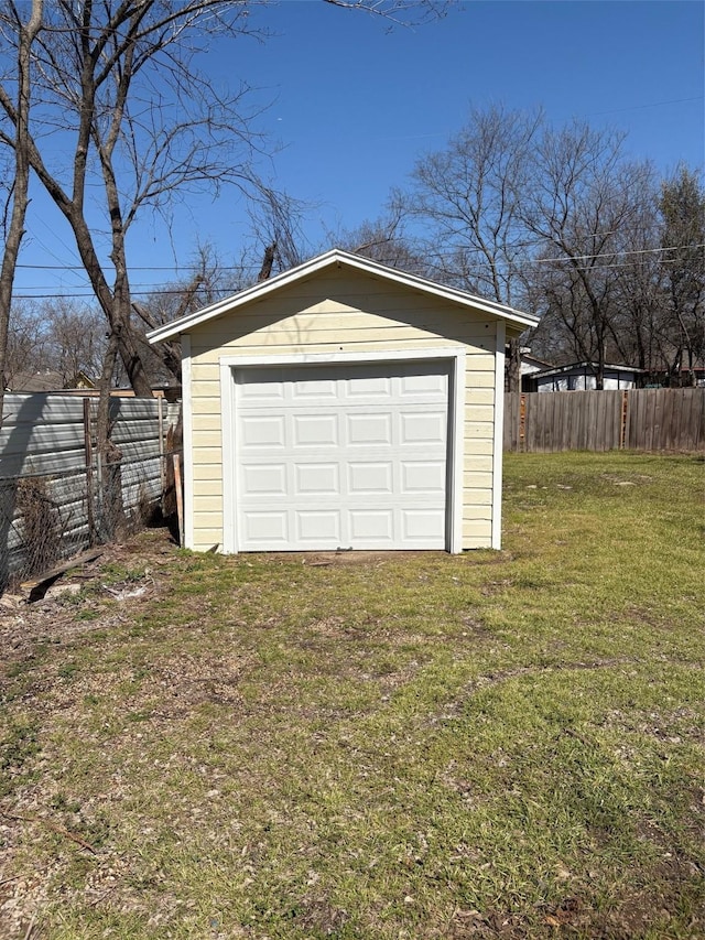 detached garage with driveway and fence