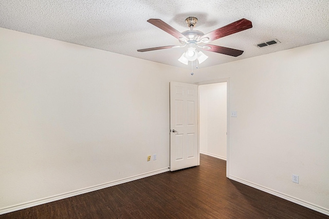 spare room featuring visible vents, a ceiling fan, a textured ceiling, wood finished floors, and baseboards