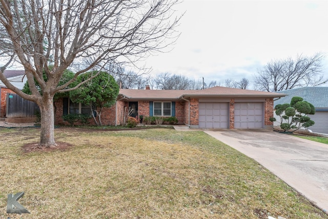 single story home with a garage, concrete driveway, a chimney, a front lawn, and brick siding