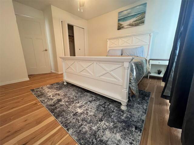 bedroom with wood finished floors and baseboards