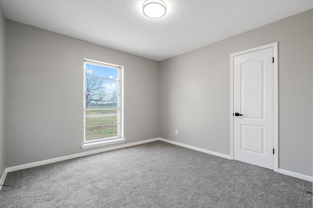 carpeted spare room with baseboards