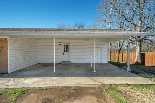 view of parking featuring a carport and fence