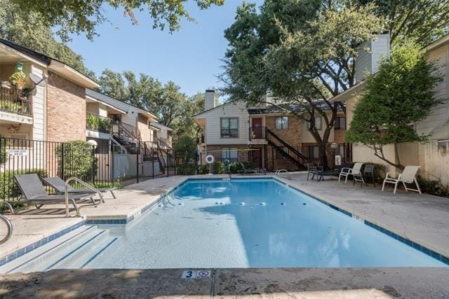 pool featuring a patio area and fence