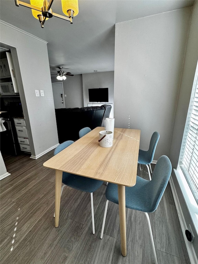 dining space featuring wood finished floors and baseboards