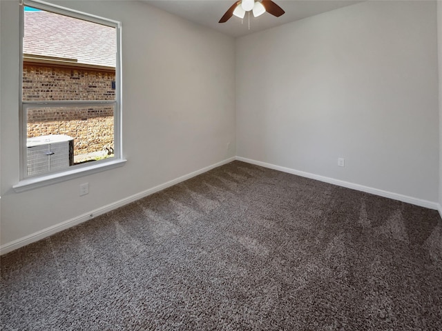 carpeted empty room with plenty of natural light, a ceiling fan, and baseboards