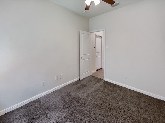 unfurnished room featuring ceiling fan, carpet floors, visible vents, and baseboards