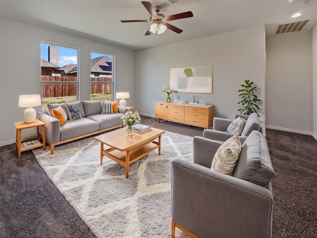 living area with carpet floors, visible vents, ceiling fan, and baseboards